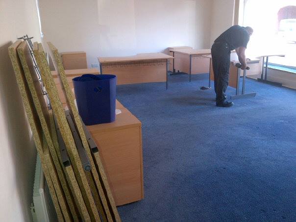 A man assembling desks